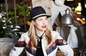 Tiffany Shlain pictured wearing a black fedora hat and red lipstick
