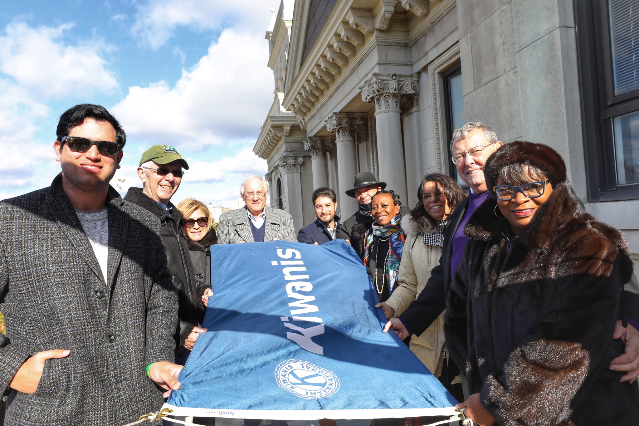 A group from the Kiwanis Club and Jersey City holding The Kiwanis Flag. 