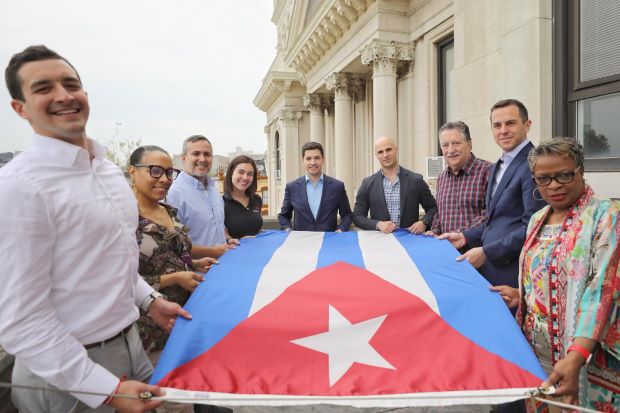 Group picture of the Cuban flag raising. 